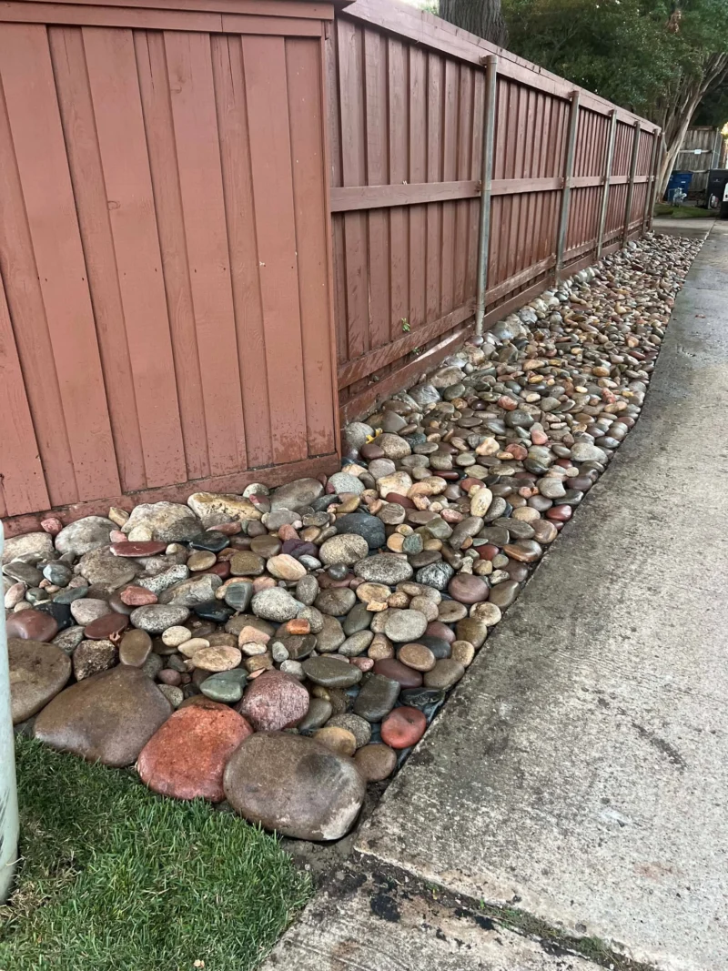 River rock fence line landscaping