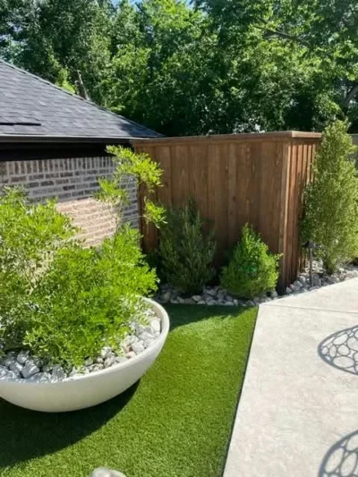 Artificial turf beside patio seating and a large planter