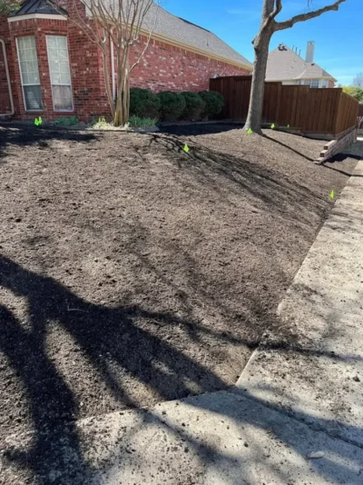 Corner brick home lawn transformation: site preparation, view 3