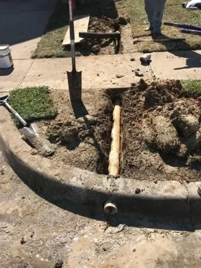 Drain pipe curb outlet installation: work in progress, view 1