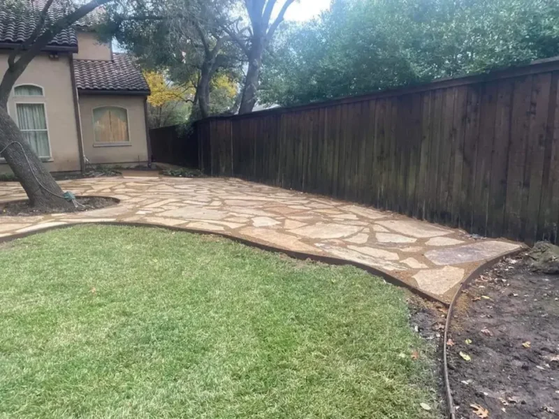 Flagstone patio beside mature tree: project view, view 2