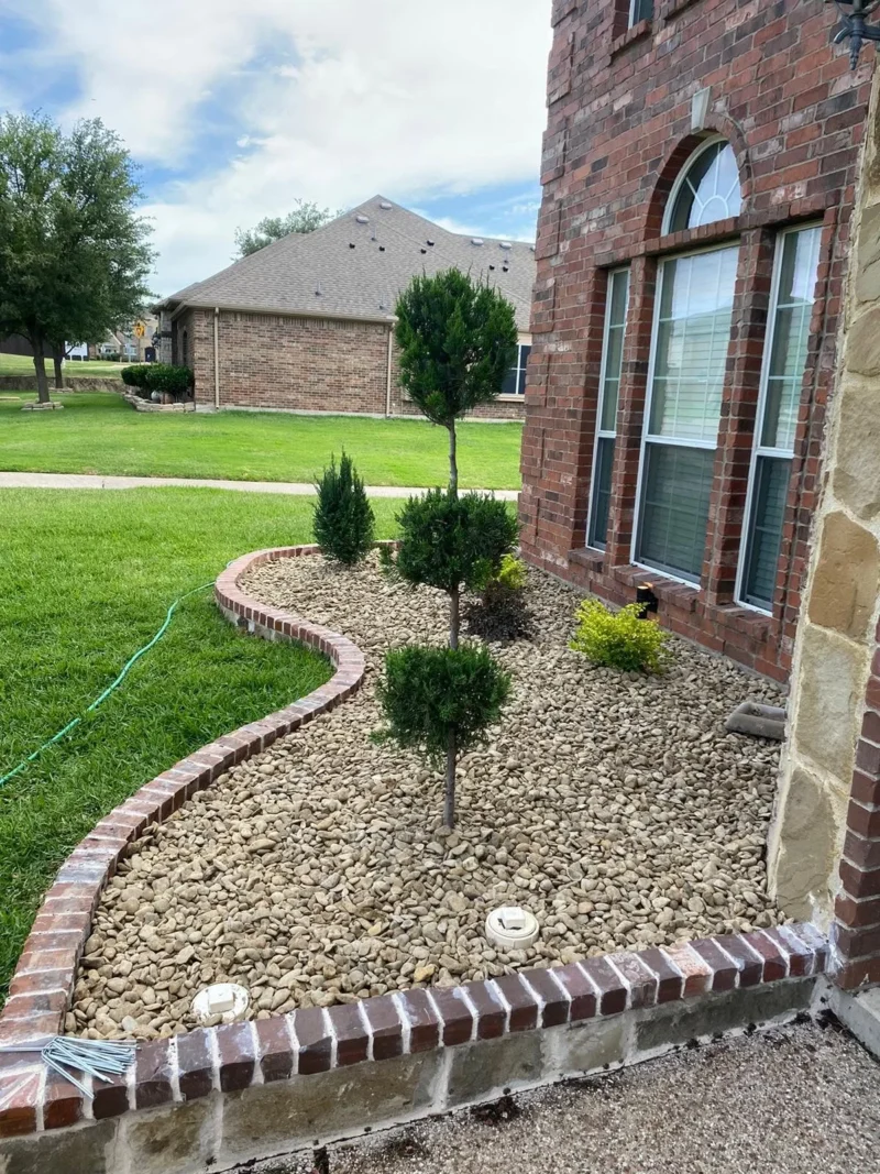 Stone flowerbed edging with brick cap and river rock beds &middot; view 6
